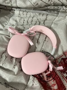 two pink breast pads laying on top of a bed