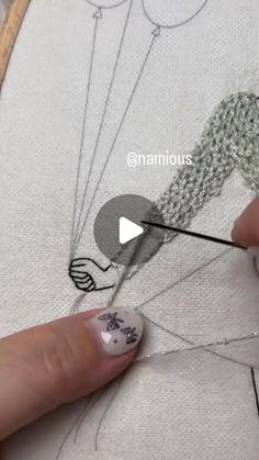 someone is using scissors to stitch the stitches on a piece of fabric with white thread