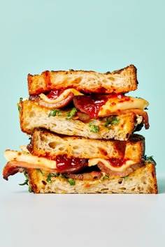 three grilled sandwiches stacked on top of each other with ketchup and cheese