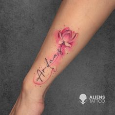 a woman's arm with a pink flower on it and the word faith written in cursive font