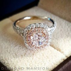 a diamond ring sitting on top of a white carpeted floor next to a box