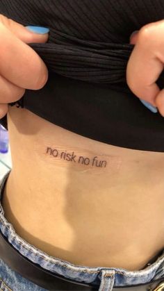 a person with a tattoo on their stomach saying, no risk no fun written on the side