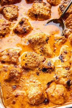 meatballs and sauce in a pan with a spoon on the side, ready to be eaten