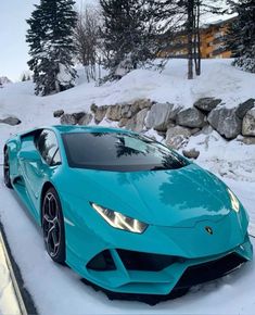 a blue sports car parked in the snow