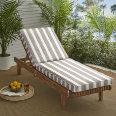 an outdoor chaise lounge chair on a patio with lemons in the foreground