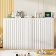 a white dresser sitting on top of a wooden floor