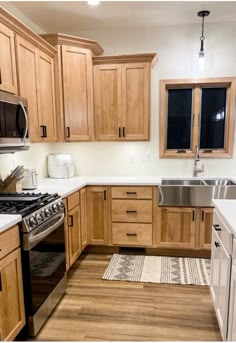 a kitchen with wooden cabinets and stainless steel appliances