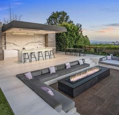 an outdoor living area with couches and fire pit