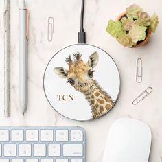 a close up of a mouse, keyboard and giraffe coaster on a table