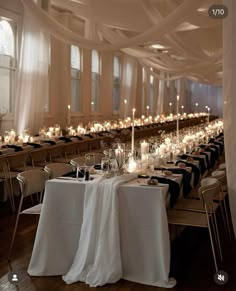 the tables are set with white linens and lit candles for an elegant wedding reception