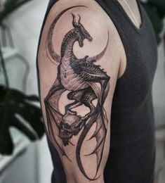 a man with a dragon tattoo on his arm