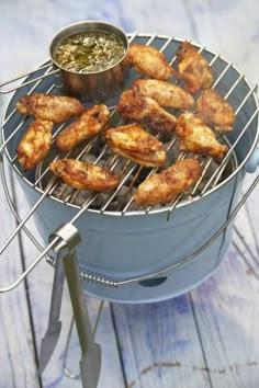 chicken wings are being cooked on the grill