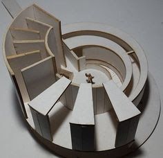 a paper model of a building on top of a white table with scissors in it