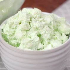 a white bowl filled with green and white food