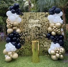 balloons and streamers are arranged in the shape of an arch