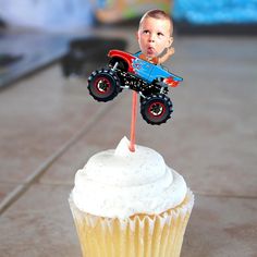 a cupcake with a toy monster truck on top