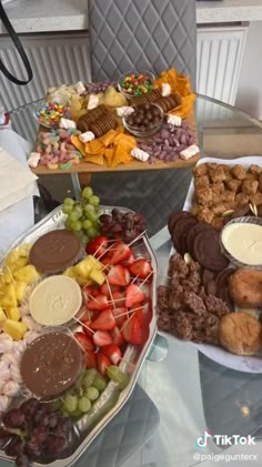 three trays filled with different types of food on top of a glass table next to each other