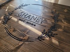 a wooden table topped with a engraved plaque on it's side and the name shaney