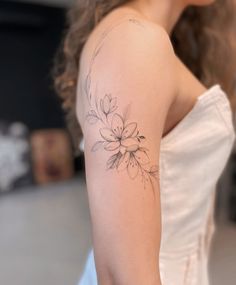 a woman with a flower tattoo on her arm