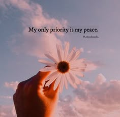 a person holding a daisy in their hand with a quote above it that says, my only priority is my peace