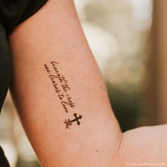 a woman's arm with a tattoo that reads, happy new year and a cross on it