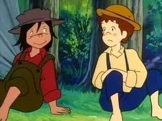 two people sitting on the ground in front of some trees and grass with one person wearing a hat