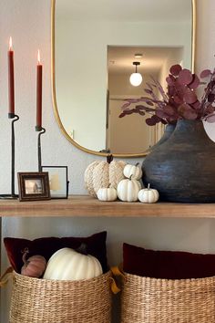 a shelf with baskets and candles on it