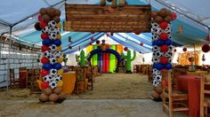 a decorated tent with balloons and decorations for a soccer themed birthday or baby's first birthday