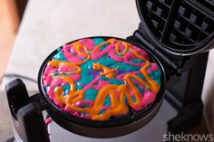 a waffle maker with colorful frosting on it