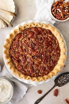 a pecan pie on a table with other pecans