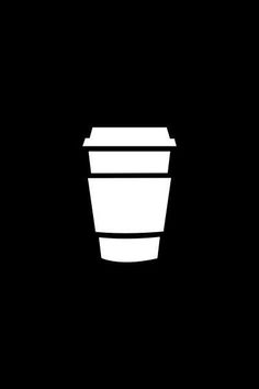 a black and white photo of a coffee cup on a dark background, with the lid down