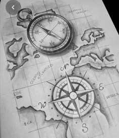 a pencil drawing of a compass and a map on top of a piece of paper