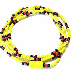 two yellow and black beaded bracelets with red, black and white beads on each strand