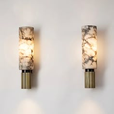 two marbled wall lights on a white wall