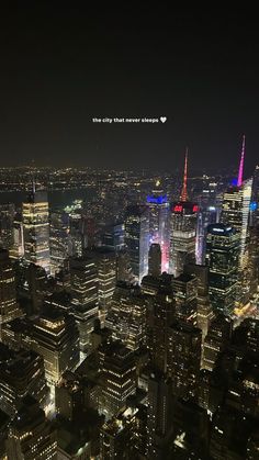 an aerial view of the city at night with buildings lit up in red, white and blue