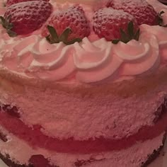 a cake with strawberries and whipped cream on top