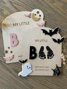 a wooden sign that says my little b is for bats and ghost feet on it