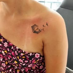 a woman with a book tattoo on her shoulder