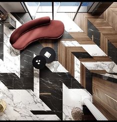 an overhead view of a living room with black and white marble flooring, red couch, and geometric wallpaper