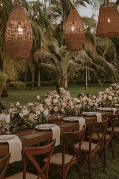 a long table set up with flowers and greenery for an outdoor wedding reception at the resort