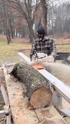 a man using a chainsaw to cut down a tree