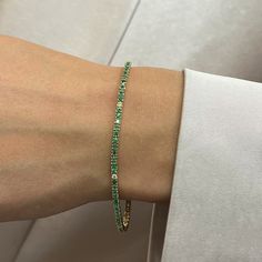 This Beautifully Crafted Tennis Bracelet Features Round Cut Green Emeralds And Diamonds Encrusted In Four Prong Setting. Crafted In 14k Yellow Gold. Total Diamond Weight: 0.09 Carat. Diamond Quality: G-H Color And Vs-Si Clarity. Total Emerald Weight: 1.98 Carats. Length: 7 Inches. Width: 2.3 Mm. Total Weight: 6.61 Gms. Bracelet Closes Securely With A Box Clasp. This Tennis Bracelet Is A Timeless Piece That Holds A Place In The Collection Of Every Jewelry Lover. Comes With A Presentable Gift Box Pink Gold Bracelet, Shiny Bracelets, Hand Cuff Bracelet, Crystal Anklet, Gold Bracelet Set, Glass Bangles, Emerald Bracelet, Bangle Ring, Diamond Tennis Bracelet