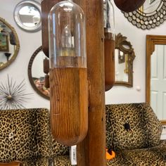 the inside of a living room with leopard print couches and mirrors on the wall