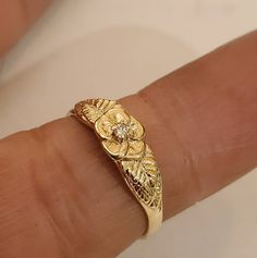 This is a beautiful 14KT yellow gold 5 pedal rose ring accented with a 3 pt si 1 gh color .03 pt diamond. Can be set with a different stone by request.This is one of my first carvings paying close attention to detail. Will always remain a classic. Comes in sizes 5 to 8. Allow 10 days handling time. Gold Promise Rings With Rose Design, Gold Diamond Jewelry With Rose Design, Gold Rings With Rose Design Fine Jewelry, Gold Rings With Rose Design In Fine Jewelry Style, Gold Flower Ring With Single Diamond, Gold Plated Yellow Gold Flower Ring, Victorian Style 14k Yellow Gold Flower Ring, Vintage Yellow Gold Flower Ring, Gold Ring