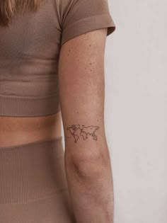 a woman's arm with a small tattoo on the left side of her body