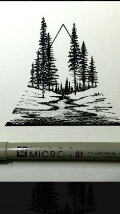 a pen is sitting on top of a piece of paper next to a drawing of trees