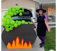 a woman dressed as a witch standing in front of a car decorated with tennis balls