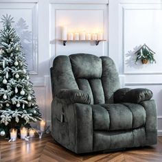 a living room with a christmas tree in the corner and two candles on the wall