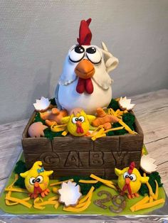 a cake made to look like a chicken in a box with eggs and chicks around it