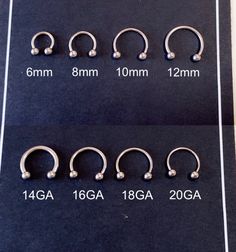 four different types of piercings are shown on a black sheet with white dots in them